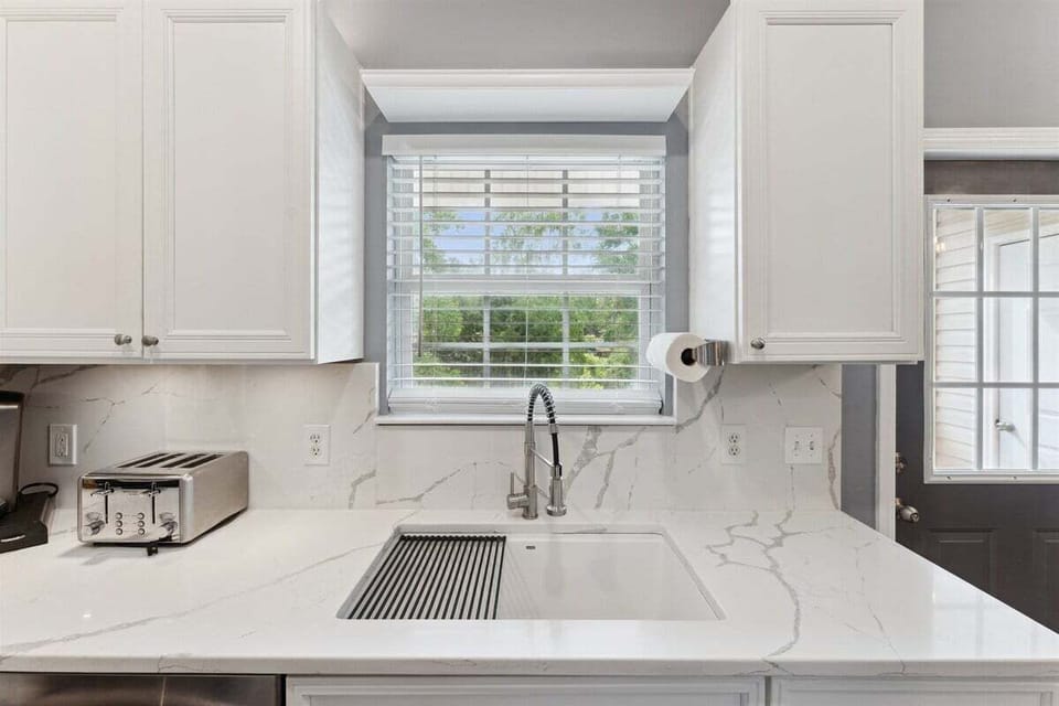 Chic farmhouse sink adds charm and function to your stay.
