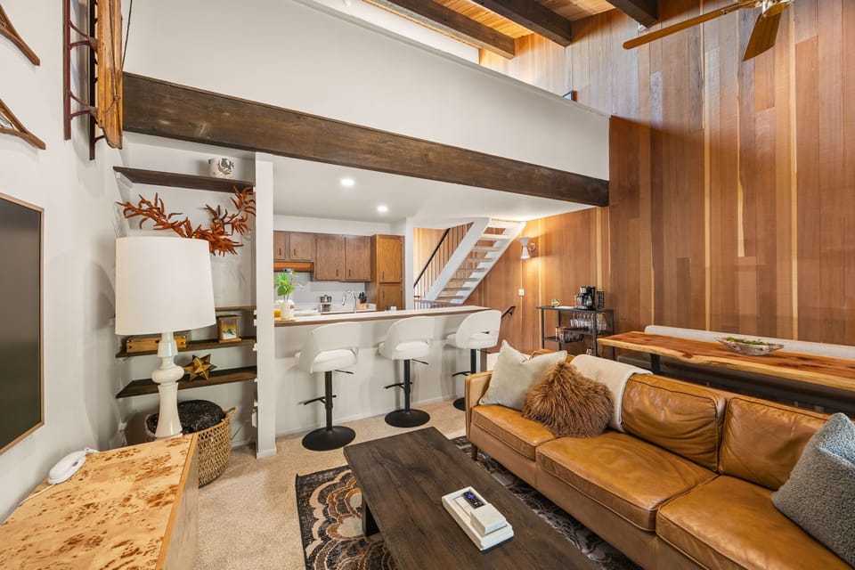 View of the kitchen from the main living area, with a breakfast bar for three