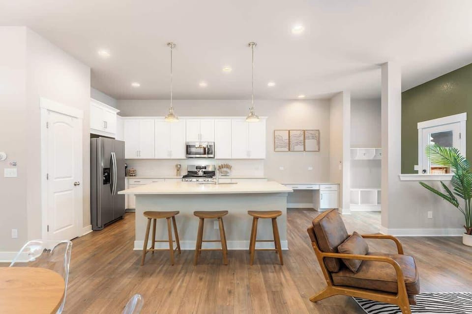 Bright modern home with cozy living room, open kitchen with island and stainless steel appliances, and spacious dining area. Perfect spaces for long stays with family or friends. Your home away from home!
