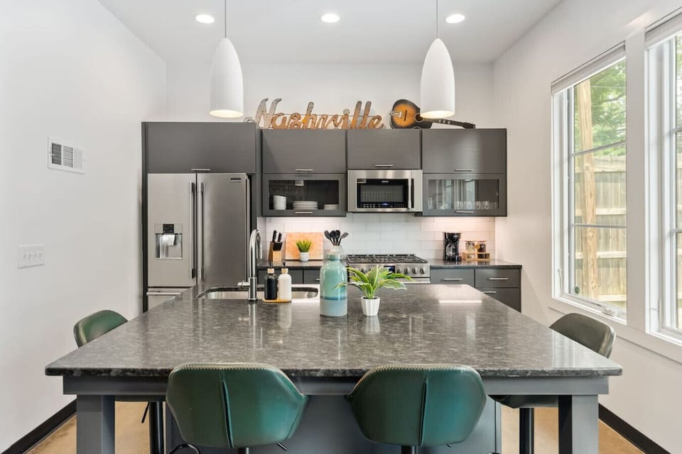 Updated, fully-equipped kitchen with high-end appliances and seating for four at the counter. Enjoy your drip coffee + coffee grounds in the morning.