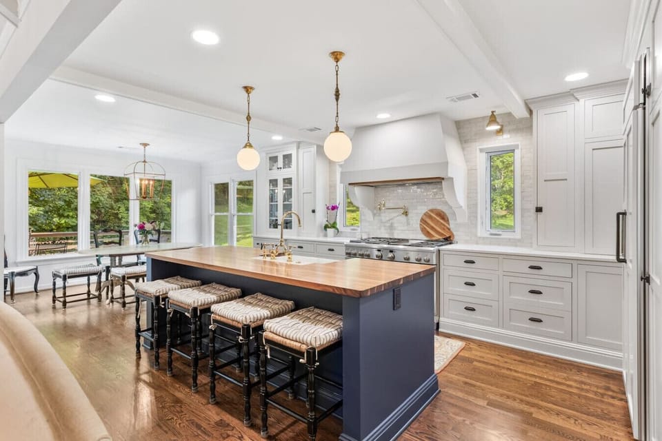 Recently updated state-of-the-art kitchen with a gas range, farm sink, all the dishware and appliances you might need, and seating for four at the kitchen island.