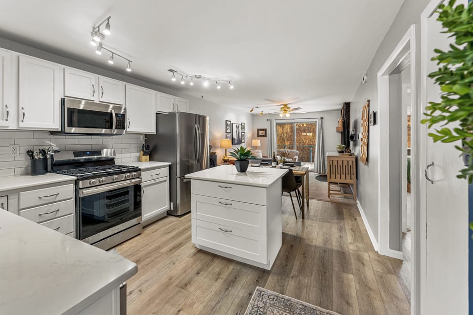 - Bright and modern kitchen opens seamlessly into dining and living areas for easy flow
- Central island provides extra prep space or a spot to sip morning coffee
- Enjoy mountain comfort with stylish finishes and wood look flooring