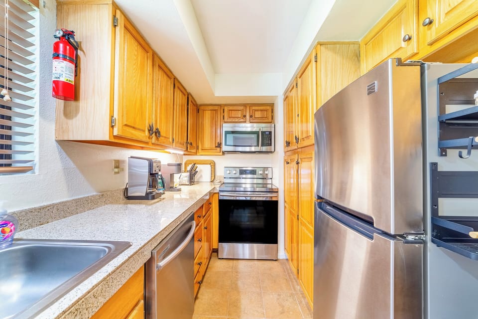 Full kitchen has granite countertops and updated stainless steel appliances.