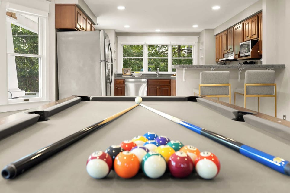 Friendly Competition Zone: A game room designed for fun—pool table, sun-drenched seating, and good vibes all around.
