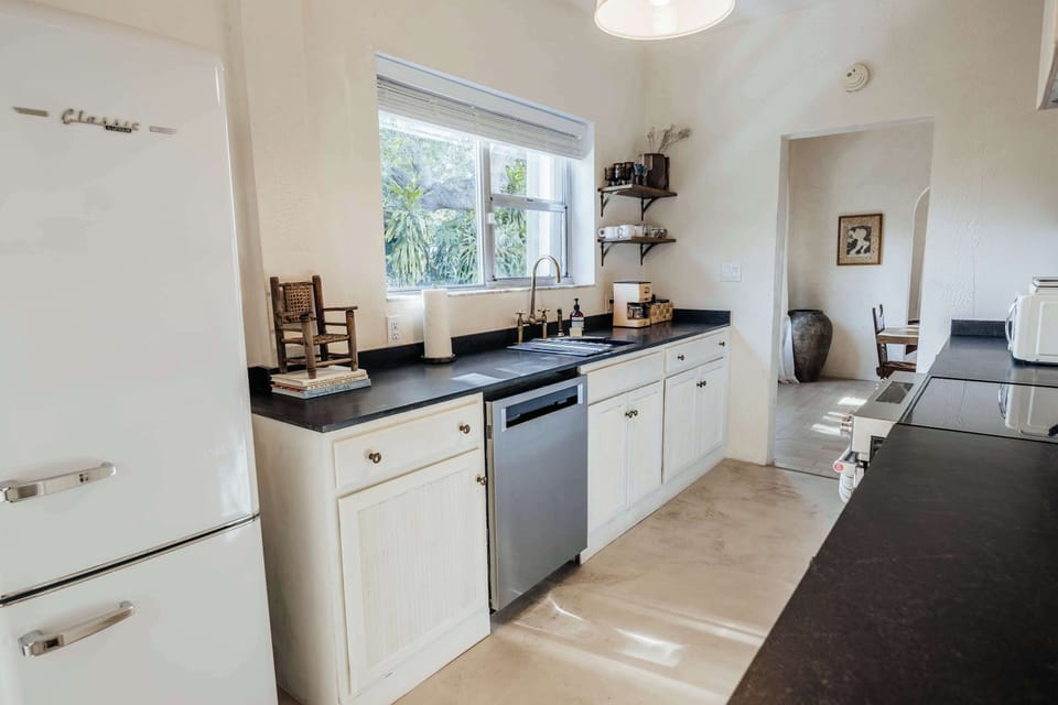 Kitchen with microwave, knife set, cook books, cutting board and more