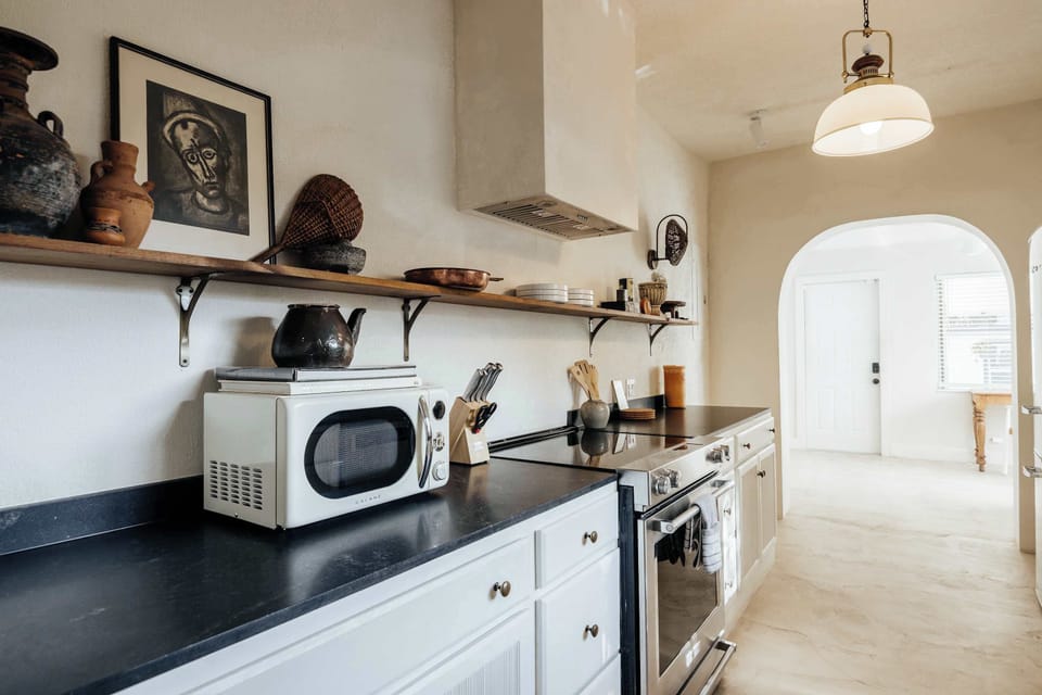 Full kitchen featuring natural light through kitchen window. Stove, oven, microwave, Fridge, Freezer, sink, dishwasher and all of the cookware you need to make a meal