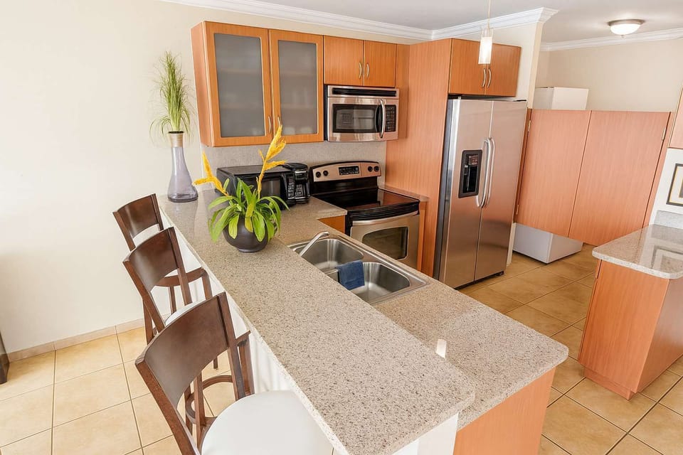 Stylish and functional kitchen with modern appliances, granite countertops, and a cozy breakfast bar — perfect for cooking and entertaining during your stay.