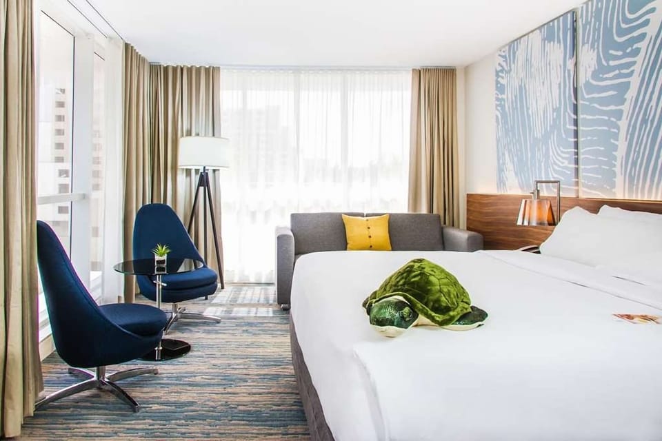 Recharge in airy comfort with a cozy sofa corner nearby.