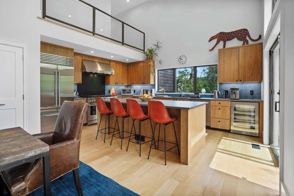 Chef’s kitchen with 8-burner gas range, double ovens, and wine fridge