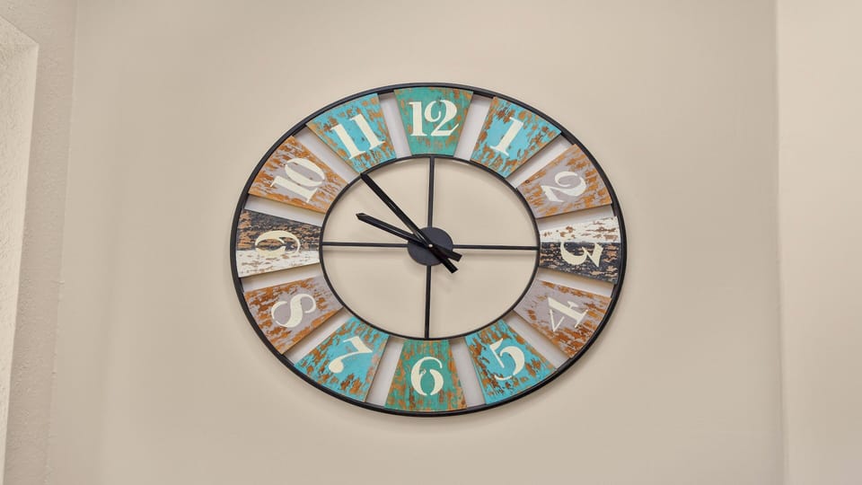 Decorative vintage-style wall clock with colorful rustic segments – a stylish accent in the hallway