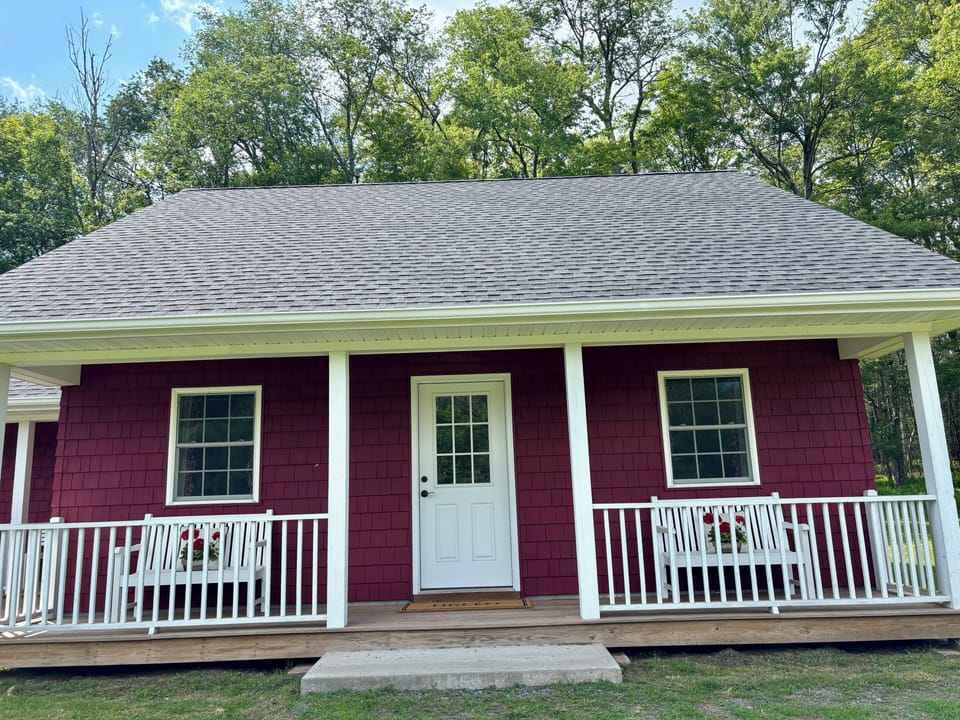 Country Cottage with porches and outdoor seating.