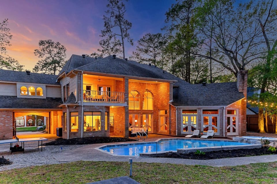 Exterior Oasis: Unwind by the pool under twinkling lights in this stunning Houston retreat!