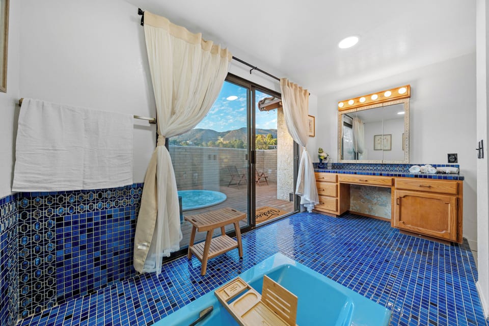 Easy transition from bath to jetted tub through a simple, elegant door.