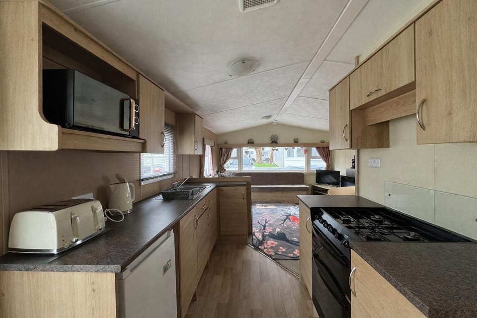 Spend quality time with your family on holiday at Naze Marine Holiday Park, where you can unwind in a comfortable kitchen area in a caravan after a day at Clacton on Sea pier.