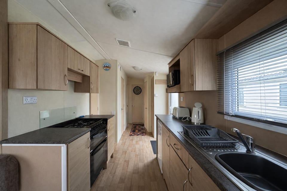 Escape to the coast for a UK staycation and enjoy the convenience of a kitchen area in a caravan at Naze Marine Holiday Park, perfect for family holidays or last minute breaks.