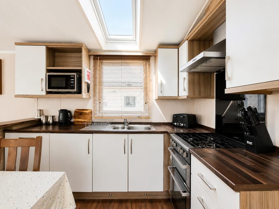 Escape to Pakefield Holiday Park on the Suffolk coast for a delightful staycation UK, where you can enjoy the comfort of a static caravan holiday complete with a cosy kitchen area.