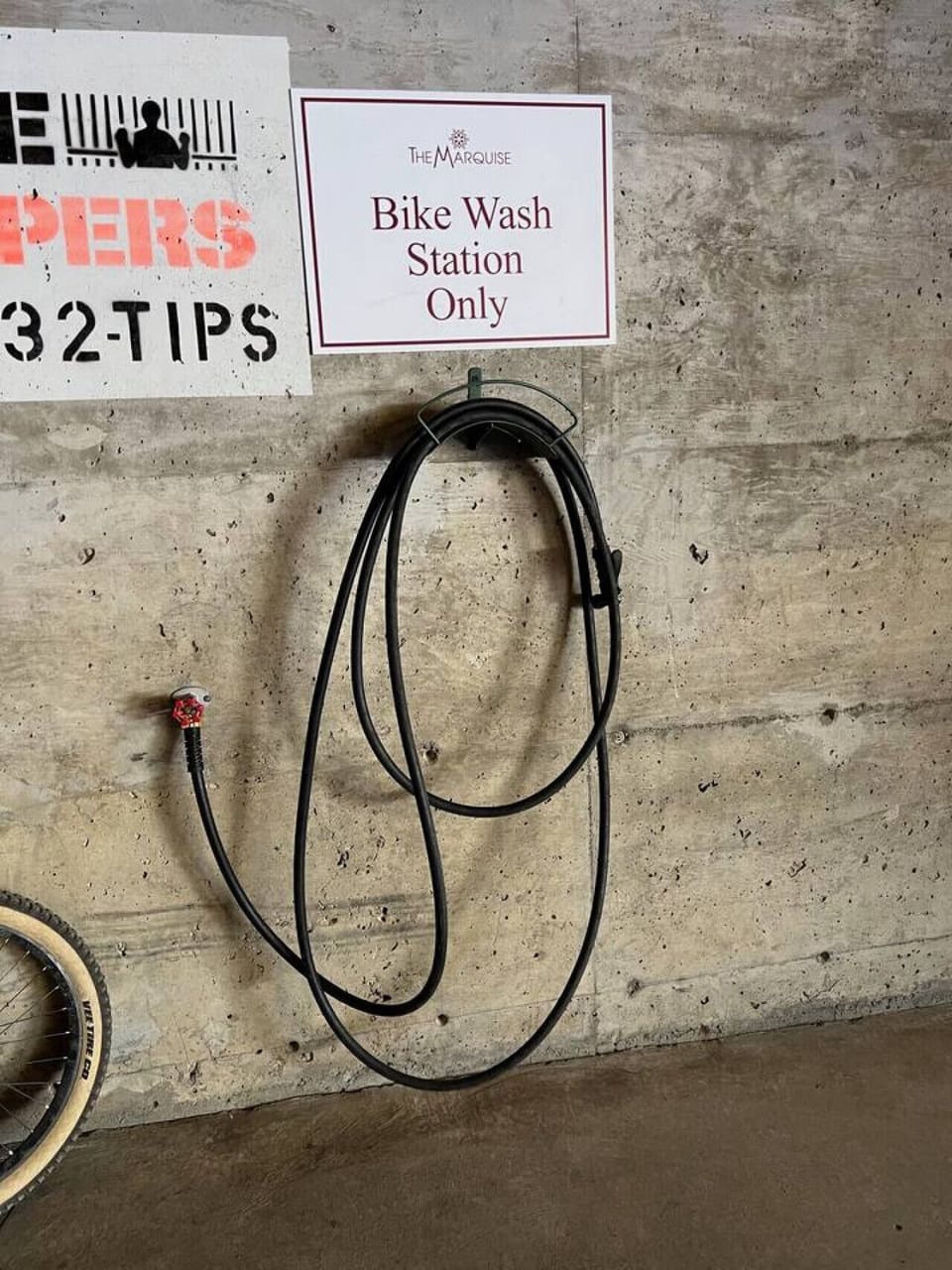 The bike wash station is located across from the bike storage