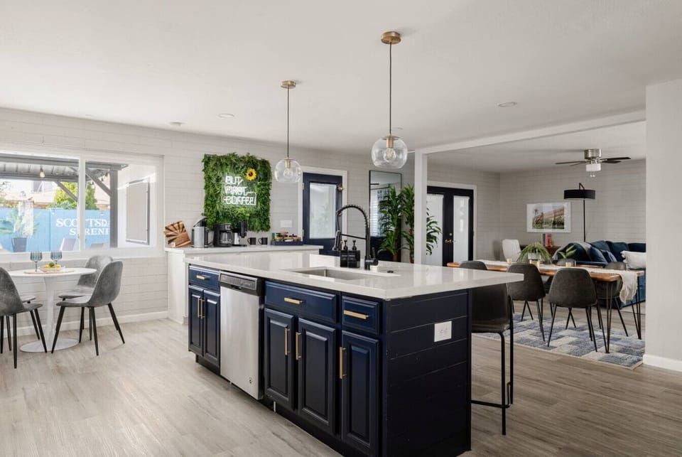 Bright, modern kitchen opens to the dining and living areas. Fully equipped with everything a chef needs to cook, gather, and enjoy.