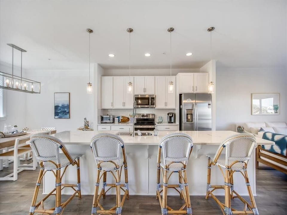 The contemporary kitchen features sleek finishes and ample seating at the counter, creating a welcoming atmosphere for family gatherings.