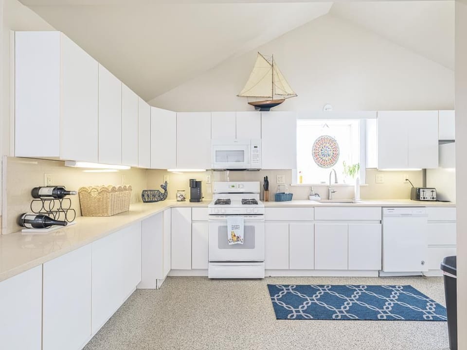 The kitchen features ample counter space, perfect for preparing meals for a crowd.