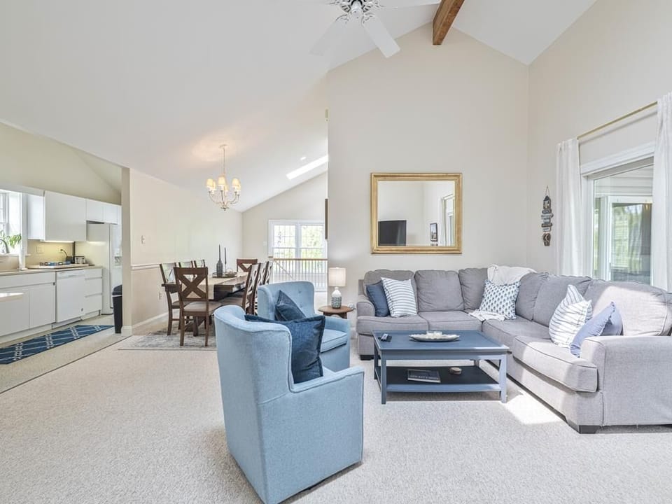 Large living area with a sectional sofa and high ceilings, perfect for unwinding after Cape May adventures.