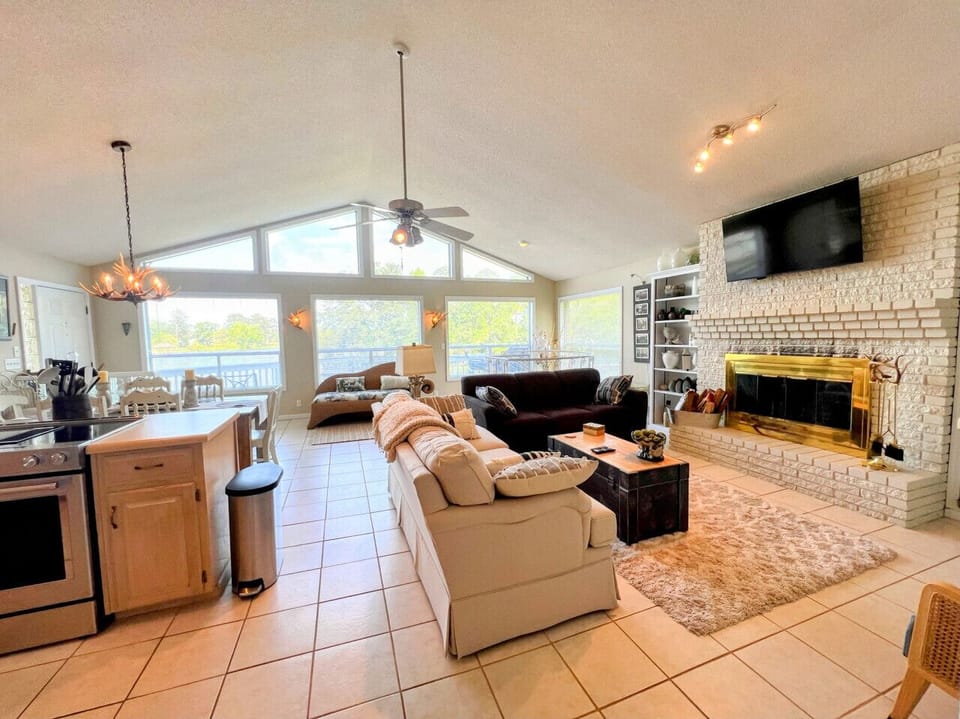 Main level living, kitchen and dining area on the main level with floor to ceiling windows overlooking Weiss Lake