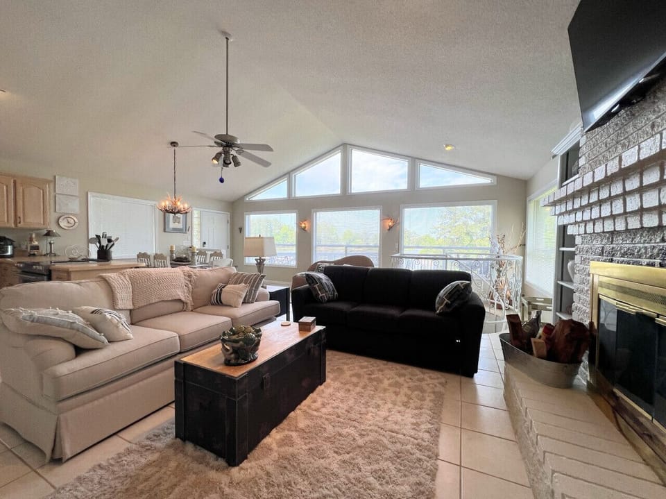 Main level living, kitchen and dining area on the main level with floor to ceiling windows overlooking Weiss Lake
