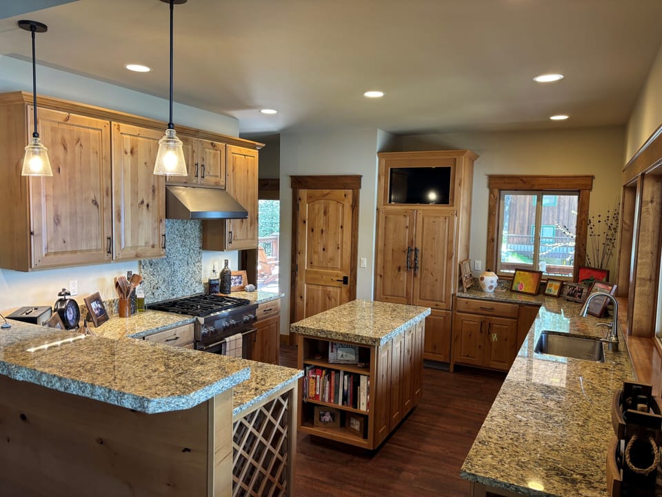 Kitchen Upstairs with main pantry to the left of the refrigerator.