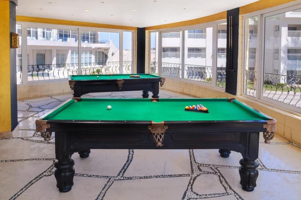 Challenge each other to a friendly game of billiards.