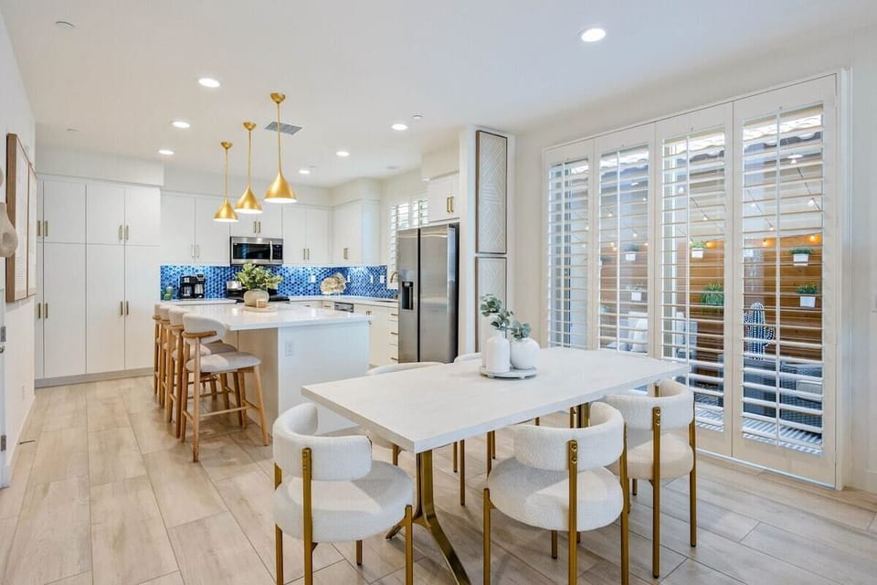 The dining table with the kitchen and living room all connected.