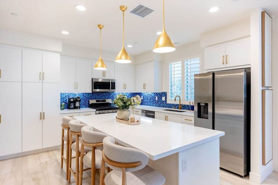 Four bar stools at the kitchen island make it easy to grab a quick bite or coffee.