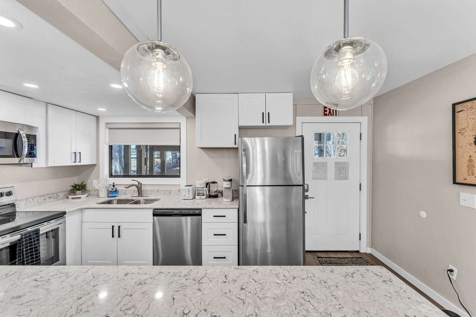 Kitchen: Main floor, drip coffee maker, Keurig, toaster, cooking utensils, tableware