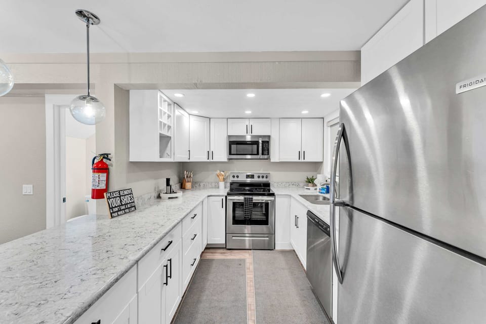 Kitchen: Main floor, drip coffee maker, Keurig, toaster, cooking utensils, tableware