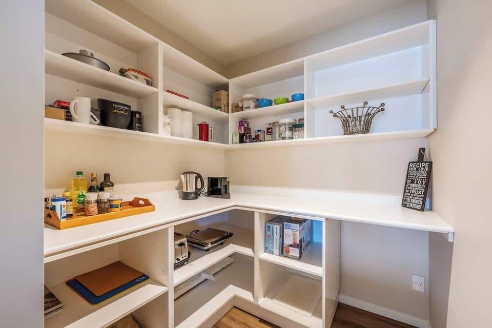 The spacious pantry offers ample storage for all your groceries and cooking essentials. Keep everything organized and easily accessible during your Queenstown stay.