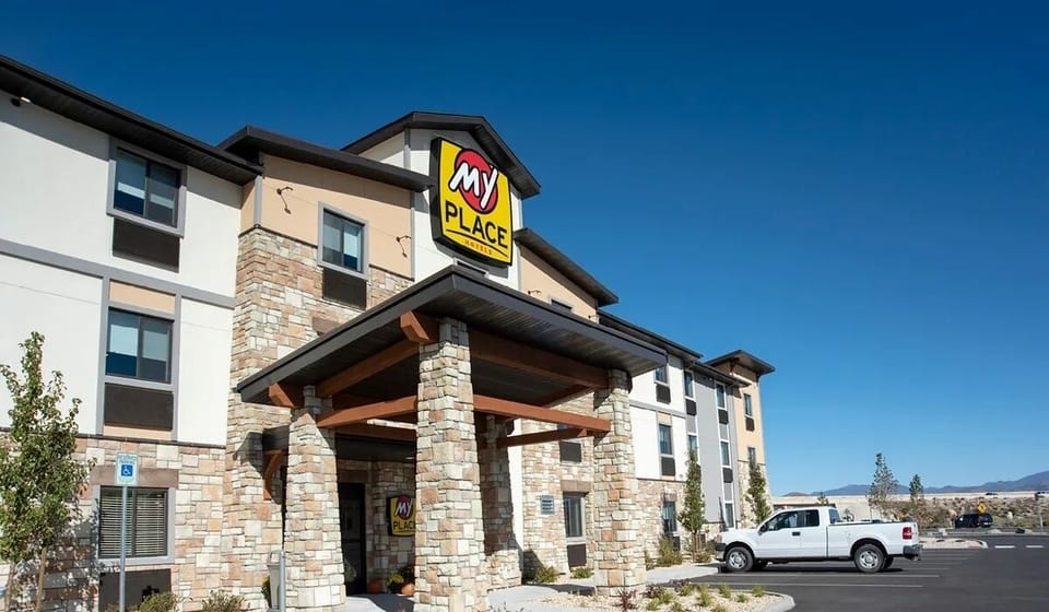 Pull up to a modern hotel facade under clear skies.