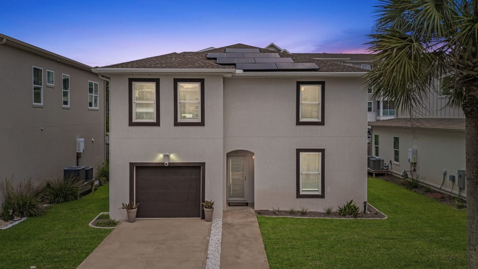 Front exterior shot of a two-story house at sunset.