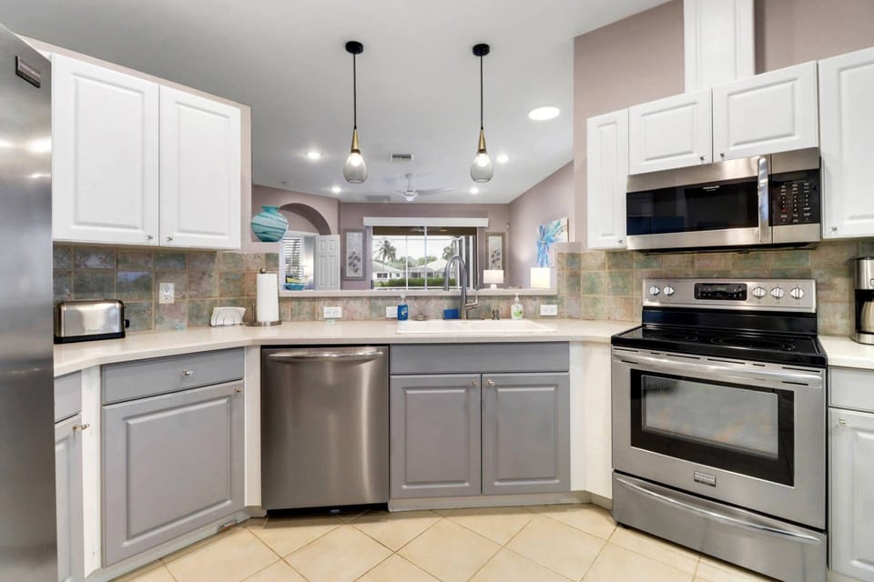 The kitchen opens to the main living area and is equipped with updated appliances, including a refrigerator/freezer, stove, microwave and dishwasher.