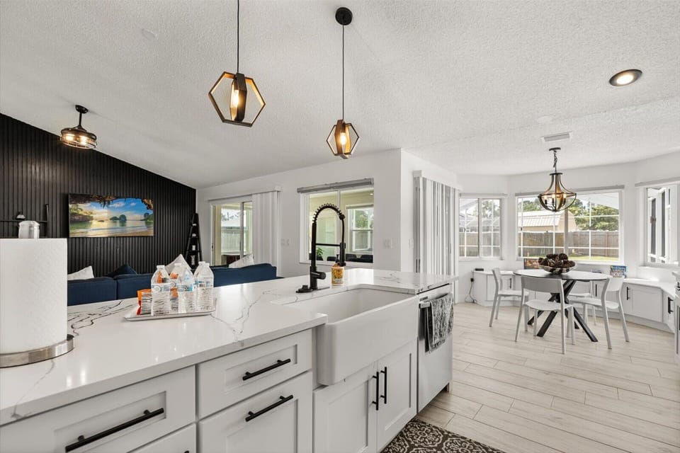Cook up delicious meals in a fully equipped kitchen featuring sleek countertops, stainless steel appliances, and an inviting island perfect for casual breakfasts.