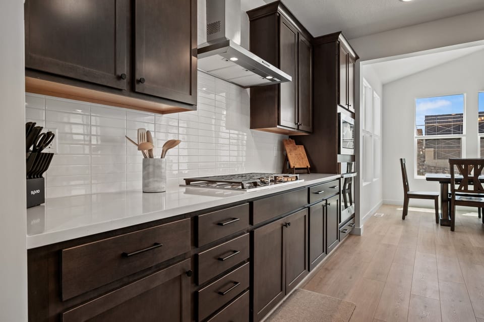 A dream kitchen for cooks—gas stove, double oven, and expansive countertops for all your culinary creations.