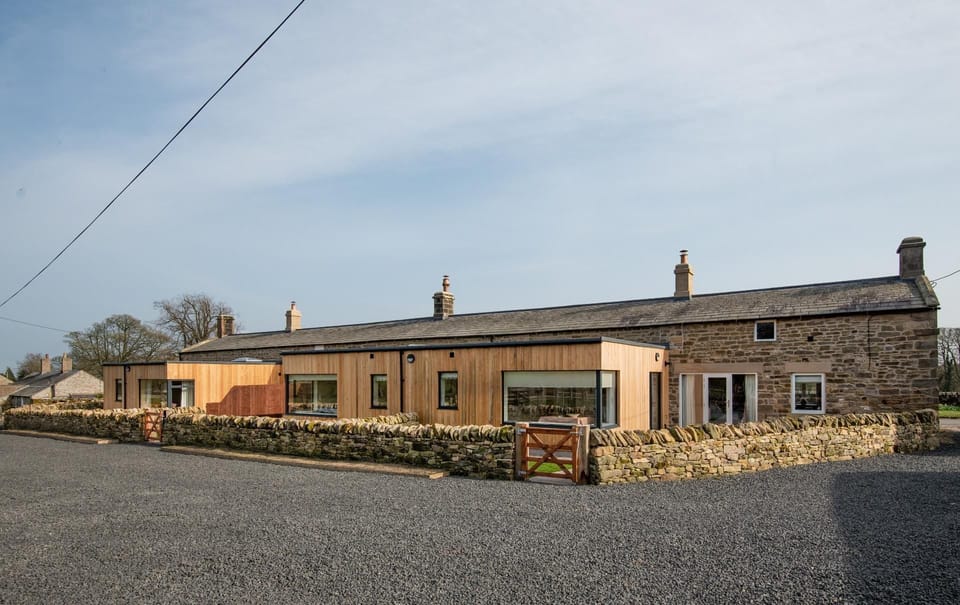 Lakeside Cottages - rear aspect of the restored cottages with modern extensions built within the enclosed gardens