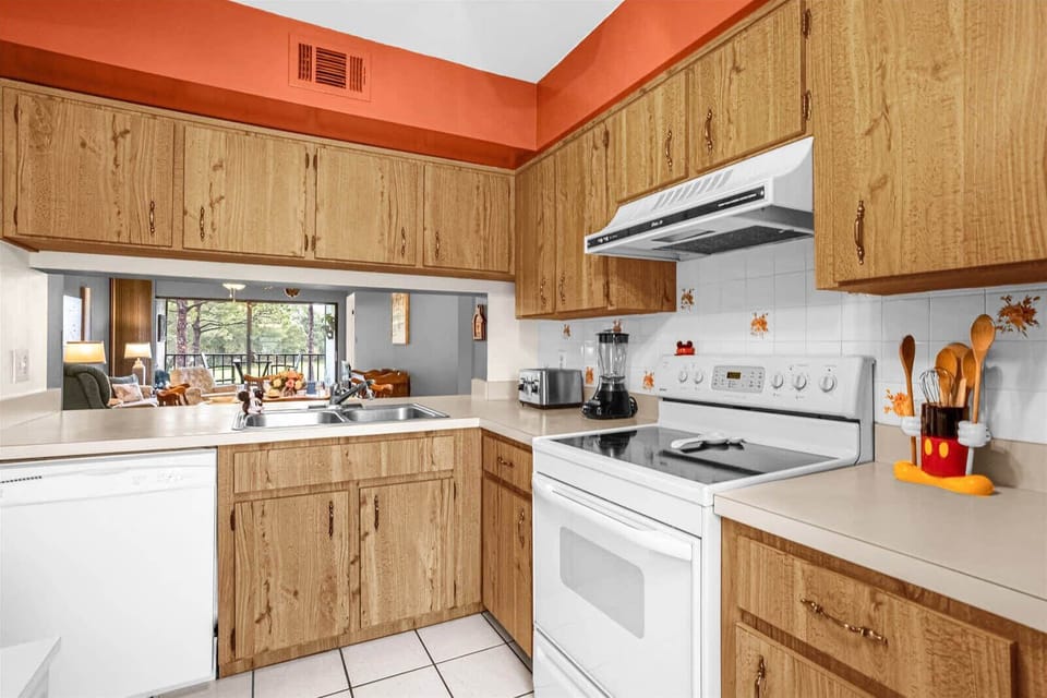 Fully Equipped Kitchen With Ample Counter Space And Wooden Cabinets