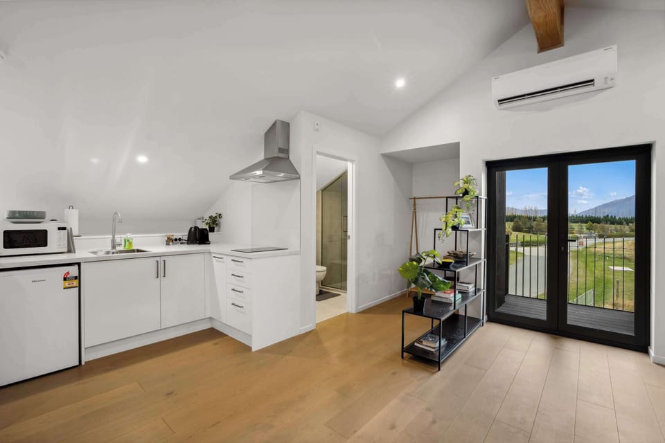 Compact kitchen with modern appliances and balcony access