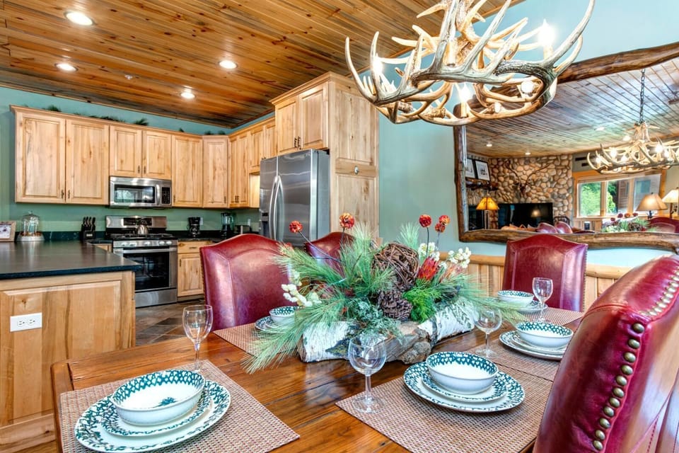 Dine at the large farmhouse-style table with seating for six under warm wood-paneled ceilings. TWL-12C