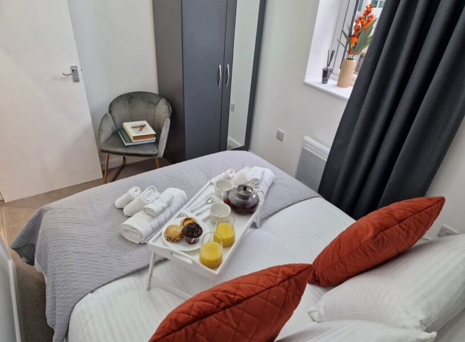 Comfortable sleeping space with quality bed linens, extra pillows, blackout shades, and clothing storage. Essentials like washer, dryer, iron, hangers, and drying rack make longer stays easy.