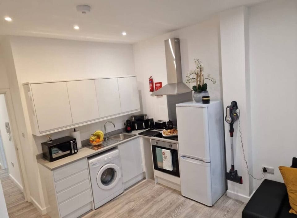 Fully equipped kitchen with refrigerator, freezer, stove, oven, microwave, dishwasher, toaster, kettle, and coffee maker. Cooking basics, dishes, silverware, and wine glasses are provided for easy meal preparation.
