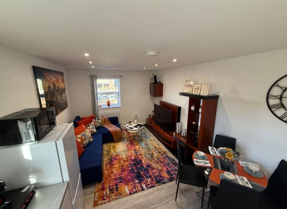 A bright and welcoming space with comfortable seating and a TV, perfect for relaxing after a day out.