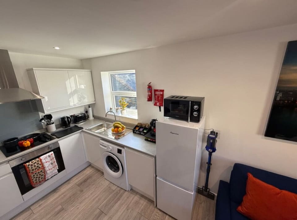 Fully equipped with modern appliances including a stove, oven, microwave, dishwasher, and coffee maker—ideal for home-cooked meals.