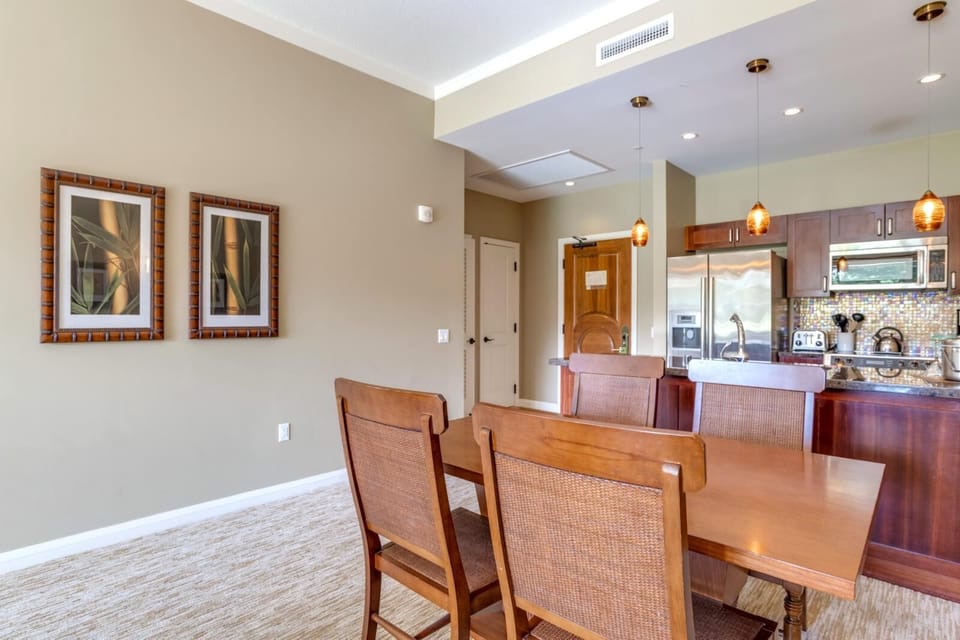 Stylish dining area beside modern kitchen with pendant lighting accents. HKK-108