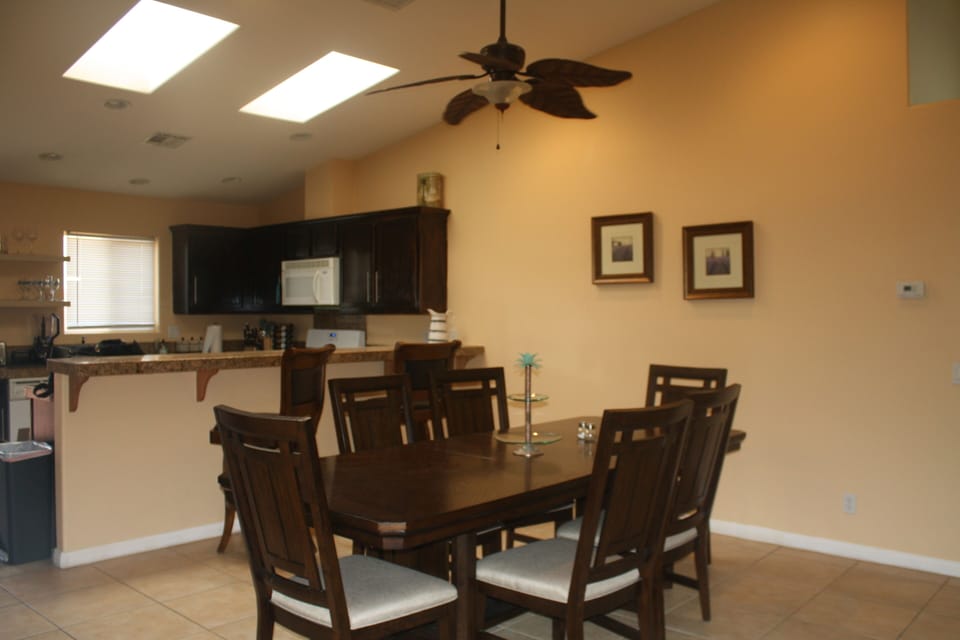 Large 6-seated dining area with open kitchen plan with island seating