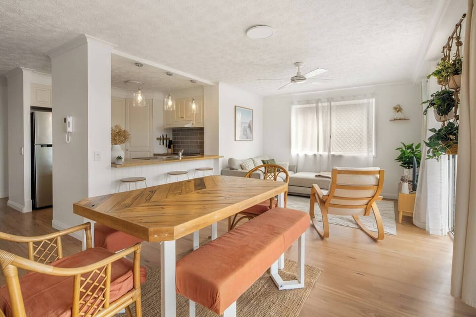 Gather for shared meals or long chats at the timber dining table, surrounded by terracotta seating and gentle natural light.